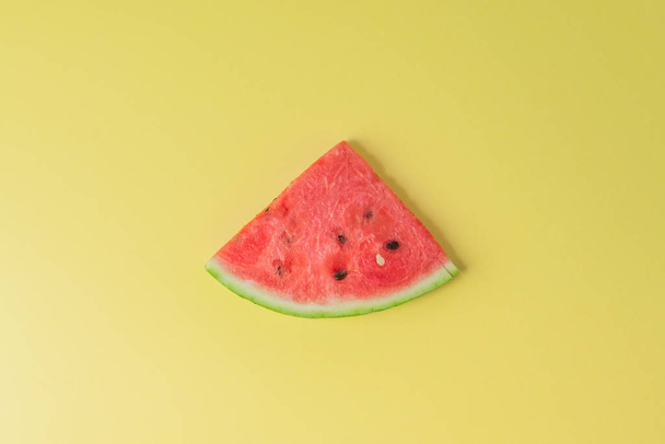 Watermelon piece on creative yellow background - Фото, зображення