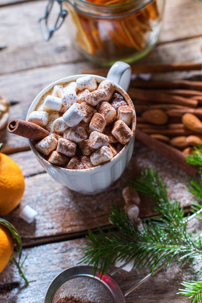 White cup of hot beverage with marshmallows cinnamon - Fotoğraf, Görsel