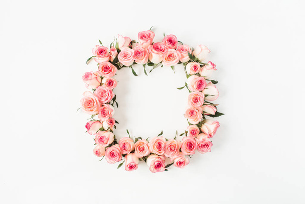 Flat lay square frame border with blank copy space mockup made of pink rose flower buds on white background. Top view floral concept. - Photo, Image