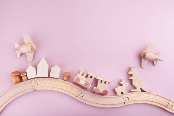 Zero waste. Eco wooden toys on pink background. Flat lay. Top view - Fotó, kép