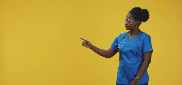 Female doctor pointing with right hand - Photo, Image