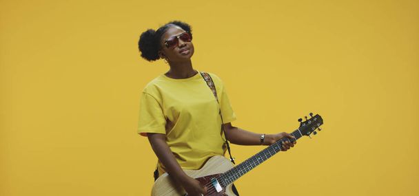Mladá žena hraje na elektrickou kytaru - Fotografie, Obrázek