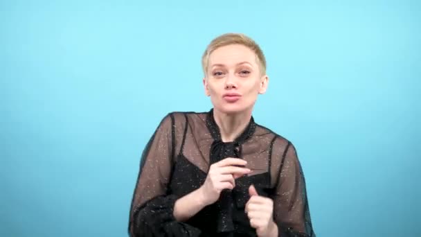 elegant woman happily dancing. blue background. Loop video. GIF design - Filmati, video