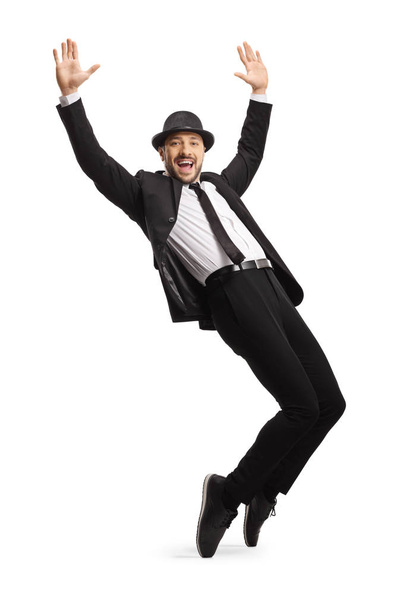 Man in suit dancing and raising hands - Фото, изображение