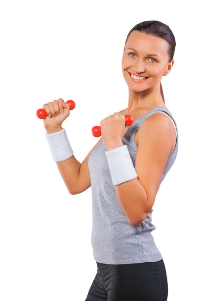 A sports female lifting weights isolated - Foto, imagen