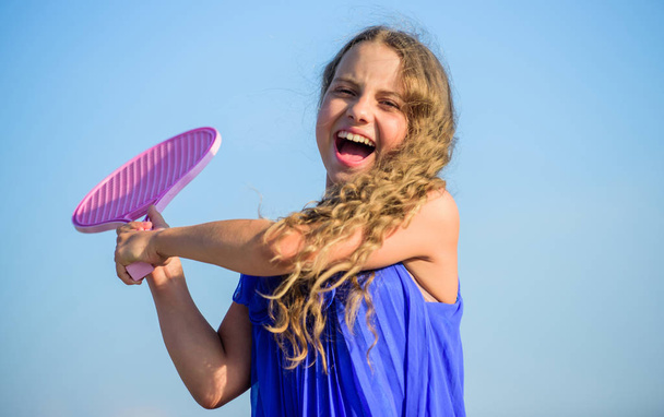 Full of energy. healthy lifestyle. small girl with tennis racquet. summer sport activity. energetic child. sport in motion. sporty game playing. summer outdoor games. play tennis. childhood happiness - Foto, Imagem