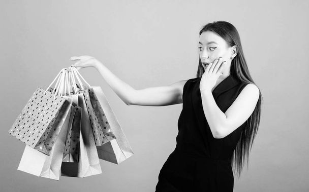 happy birthday surprise present. shopping bag. Big sales. sensual woman hold purchase package. fashion and beauty. sexy woman with long hair at shopping. Modern woman. what a great surprise - 写真・画像