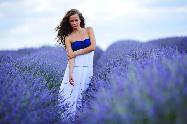 Woman standing on a lavender field - Zdjęcie, obraz