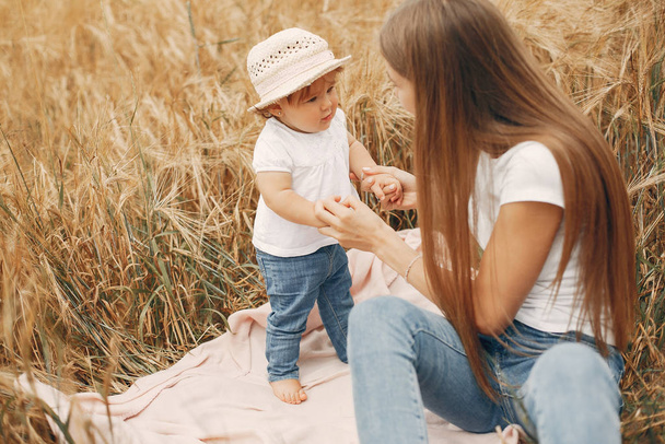 Mother with daughter playing in a summer field - Photo, Image