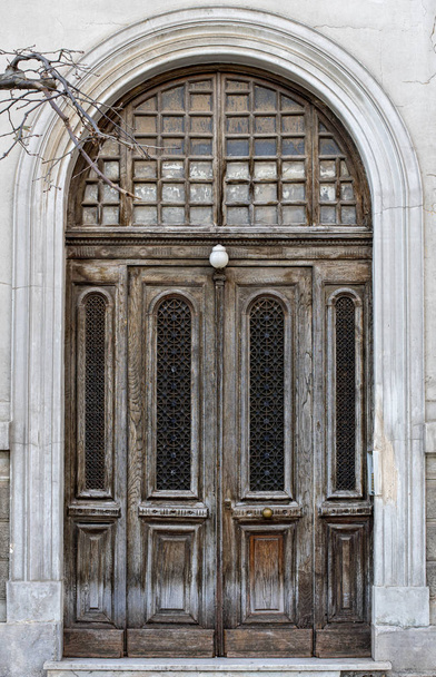 Impressive entrance, wooden weathered brown  door, classical arc - Photo, Image