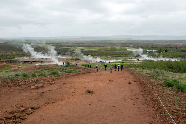 Tourists visiting Strokkur geyser in Iceland - Фото, изображение