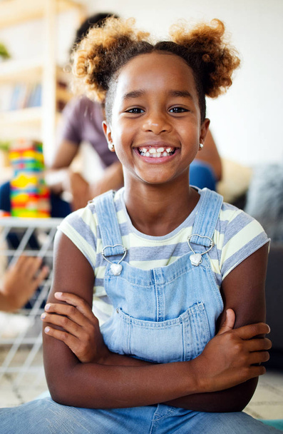 Beautiful portrait of a happy little black girl smiling - 写真・画像