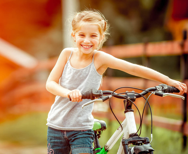 little girl riding a bicycle - Zdjęcie, obraz