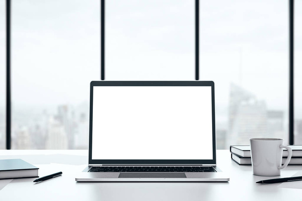 Laptop with blank white screen on a desktop on a big window background with city view, mockup. 3D Rendering - Foto, Imagem