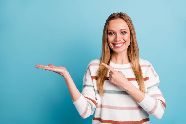Photo of cheerful positive pretty sweet woman pointing at empty space on her palm smile toothy isolated pastel blue color background - Φωτογραφία, εικόνα