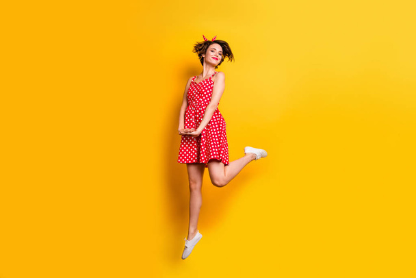 Full body photo of cheerful nice sweet girl jump enjoy spring time holidays wear good look clothing white footwear isolated over shine color background - Zdjęcie, obraz