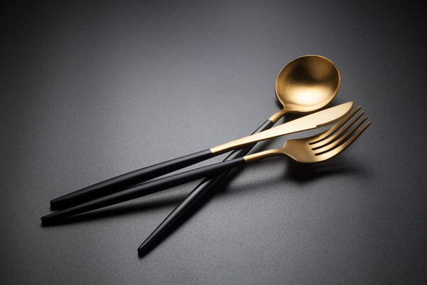 Cutlery set with Fork, Knife and Spoon on black background - 写真・画像