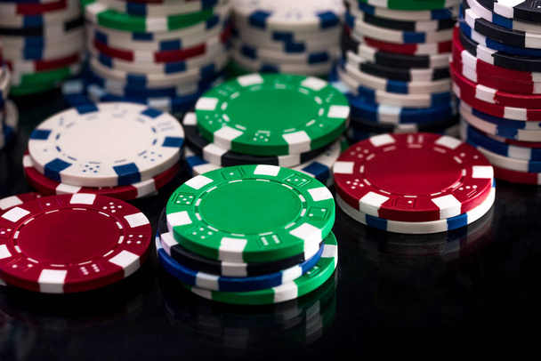Colorful casino chips on dark background closeup - Photo, Image