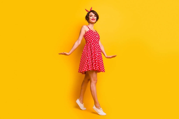 Full length photo of content pretty girl enjoy spring free time weekends go walk wear polka-dot clothes isolated over bright color background - Foto, Bild