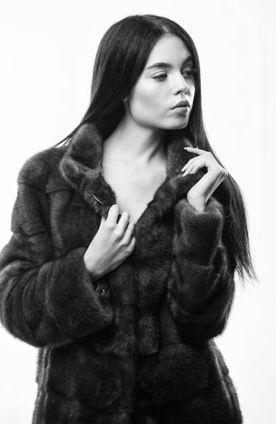 Luxurious fur. Woman attractive model wear dark soft coat. Fashion concept. Female with makeup wear mink black fur coat. Girl posing fur coat. Girl elegant lady wear fashionable coat jacket - Foto, Imagem