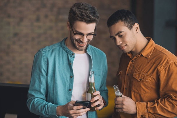 Pleasant happy man drinking with his friend - Фото, изображение