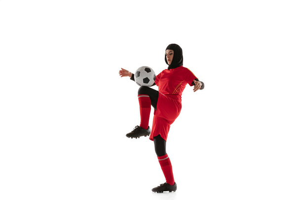 Arabian female soccer or football player isolated on white studio background - 写真・画像
