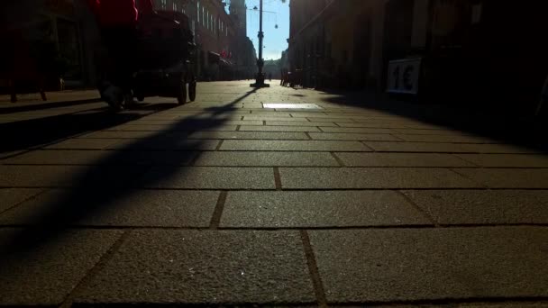 Silhouettes and shadows of people in a town on a sunny winter day - Video