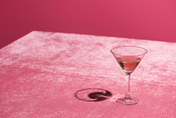alcohol drink in glass on velour pink cloth isolated on pink, girlish concept - Foto, Imagen