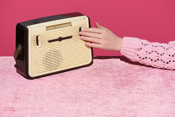 cropped view of woman with vintage radio on velour cloth isolated on pink, girlish concept  - Foto, imagen