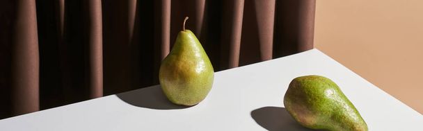 classic still life with pears on table near curtain isolated on beige, panoramic shot - Photo, Image