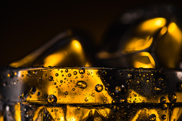 close up view of geometric faceted glass with yellow illumination in dark - Valokuva, kuva