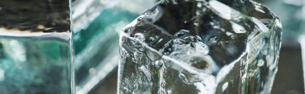 close up view of melting transparent clear square ice cubes, panoramic shot - 写真・画像
