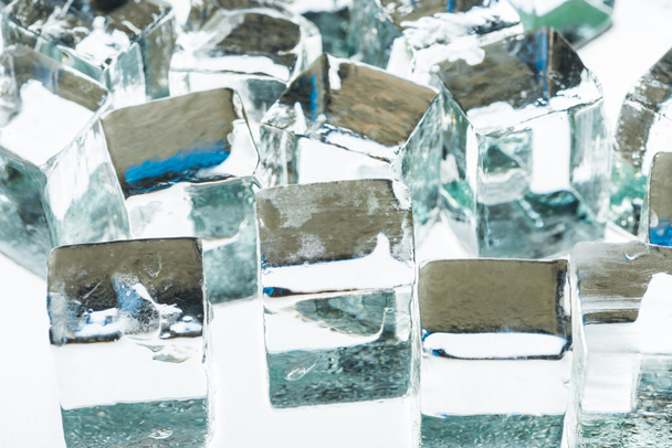 close up view of melting transparent clear square ice cubes - Foto, Bild