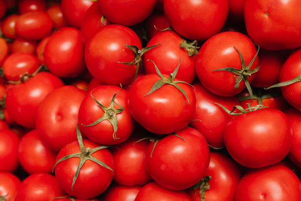 Red Tomatoes. Vegetables are stacked on top of each other. - Photo, Image