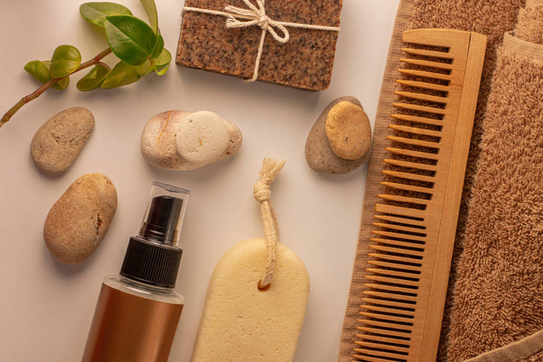 Spa and wellness concept, natural coffee scrub soap, oil cosmetics spray, peeling sand stone, wood haircomb, copy space. - Photo, Image