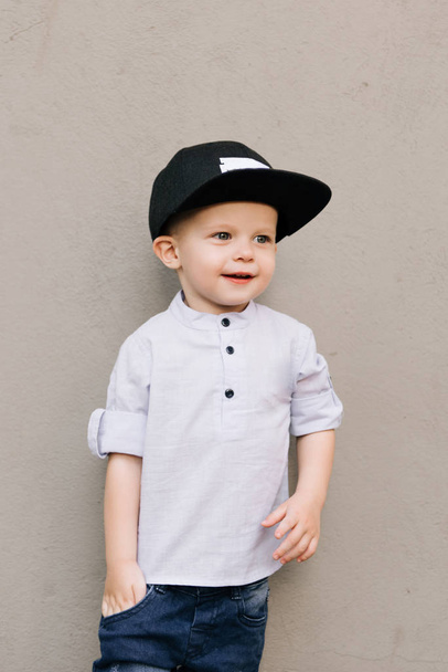 Happy stylish baby boy on grey background - Valokuva, kuva
