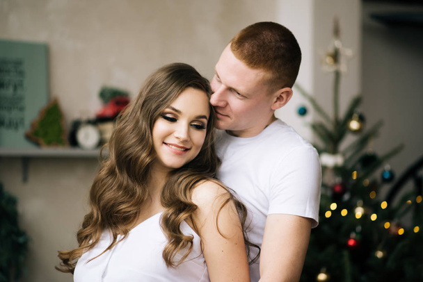 Husband hugs his pregnant wife. Stylish photo in anticipation of a miracle - Photo, image