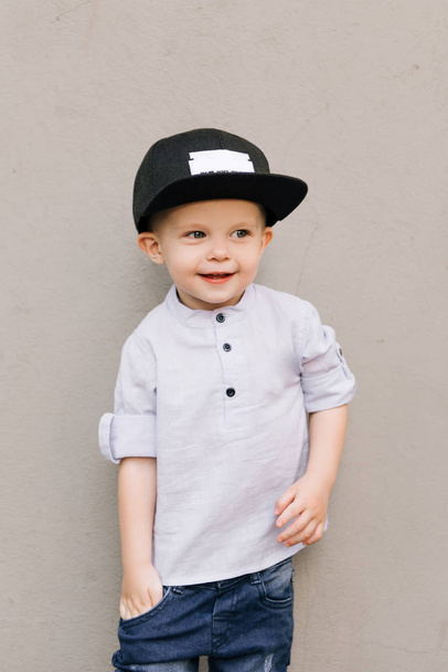 Happy stylish baby boy on grey background - Fotografie, Obrázek