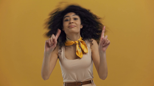 cheerful bi-racial woman showing refusal gestures isolated on dark yellow - Footage, Video