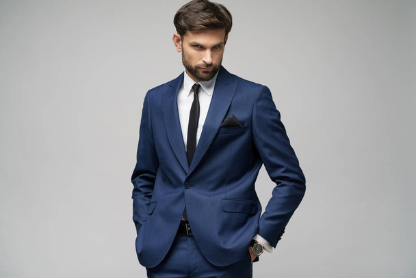 studio photo of young handsome businessman wearing suit - Foto, Imagem