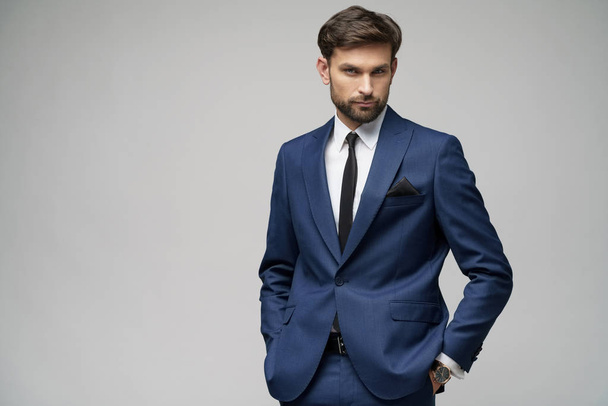 studio photo of young handsome businessman wearing suit - Foto, imagen