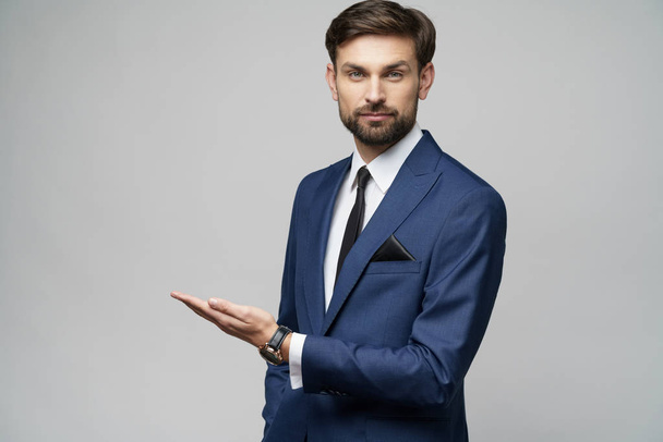 Portrait of a young businessman pointing on a copyspace with his finger - Фото, зображення