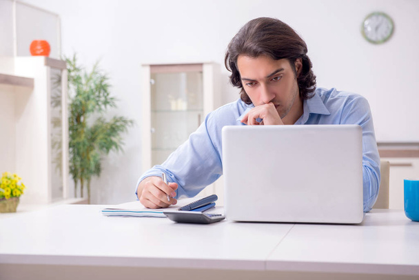 Young male employee working at home - Photo, Image