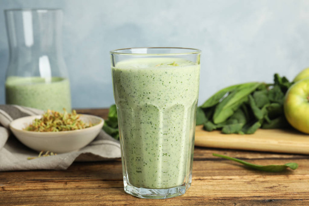 Tasty green buckwheat smoothie on wooden table - Photo, Image