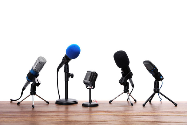 Set of different microphones on wooden table. Journalist's equip - Fotografie, Obrázek