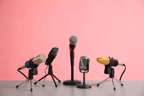 Microphones on table against pink background. Journalist's work - Valokuva, kuva