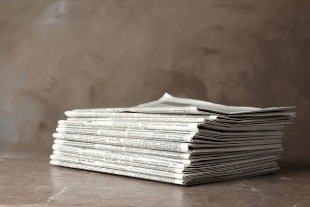 Stack of newspapers on marble table. Journalist's work - Fotoğraf, Görsel