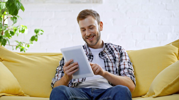cheerful man making online bets on digital tablet - Footage, Video