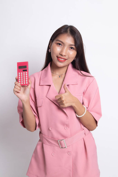 Asian woman thumbs up with calculator. - 写真・画像