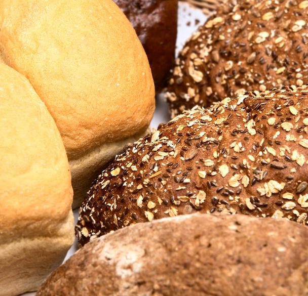 Different types of bread in the basket. Wheat, rye bread with br - Photo, Image